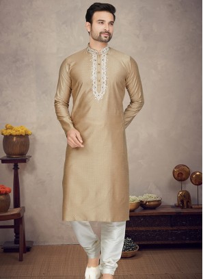 Gold Jaquard Kurta with Cream Churidar Bottoms.