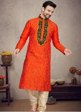 Orange Art silk Kurta with Gold Churidar Bottoms.