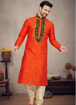 Orange Art silk Kurta with Gold Churidar Bottoms.