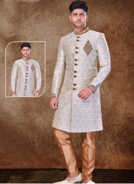 Regal Cream and Chikoo Sherwani with Jaqard Top and Dhupion Silk Bottom.