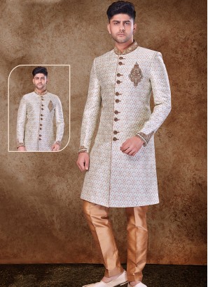 Regal Cream and Chikoo Sherwani with Jaqard Top and Dhupion Silk Bottom.